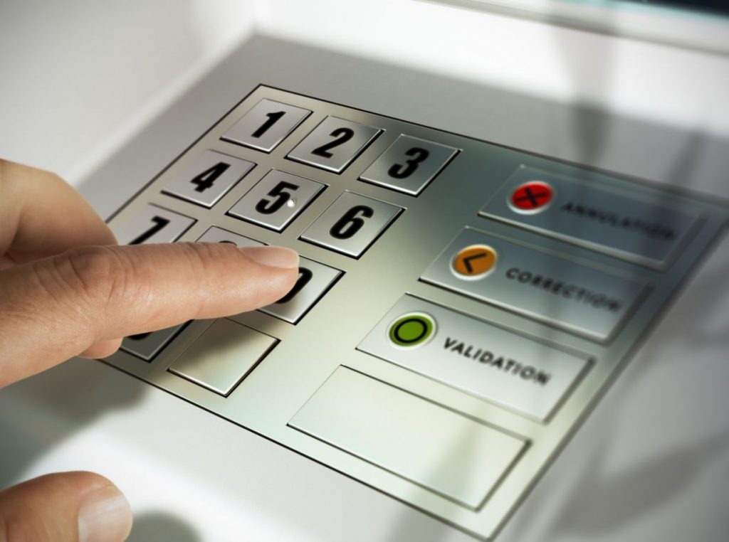 Main entrant un code PIN sur un distributeur automatique en Belgique – accès au cash et enjeux du modèle Batopin